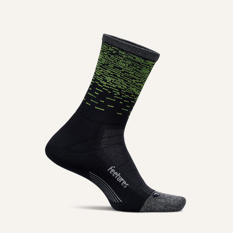 Feetures Elite Light Cushion Reflective Mini Crew socks, black with gray toe and heel, neon green reflective accents, side view.