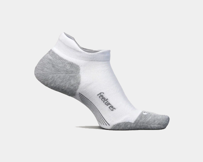 Feetures Elite Max Cushion No Show Tab socks in white with gray accents, targeted compression for arch support, side view.