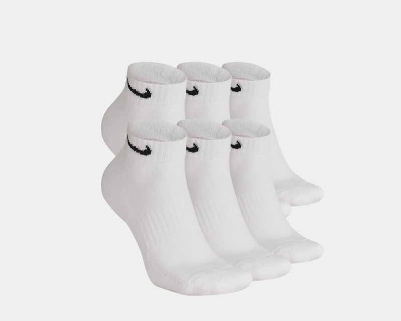Nike Everyday Cushion Low Socks in white with ribbed cuffs and black swoosh logo, front angled view showing a pack of six pairs.