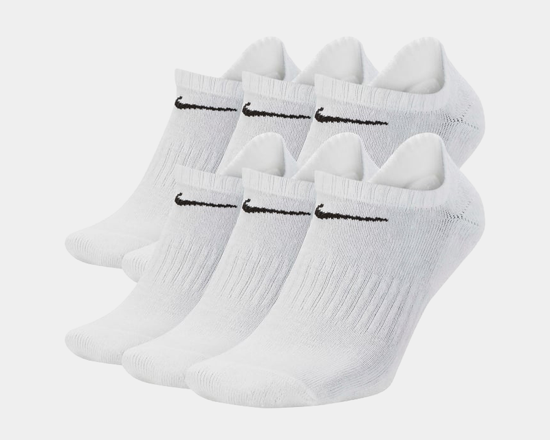 Nike Everyday Cushioned Training No-Show Socks in white with black swoosh logo, ribbed texture and cushioned design, front angled view.