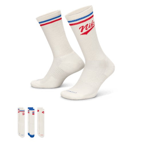 Nike Everyday Plus Crew Socks in white with red and blue accents, ribbed cuffs, and arch support, angled side view.