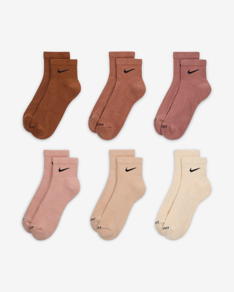 Nike Everyday Plus Cushioned Ankle Socks in brown, pink, and beige tones with ribbed cuffs and black swoosh logo.
