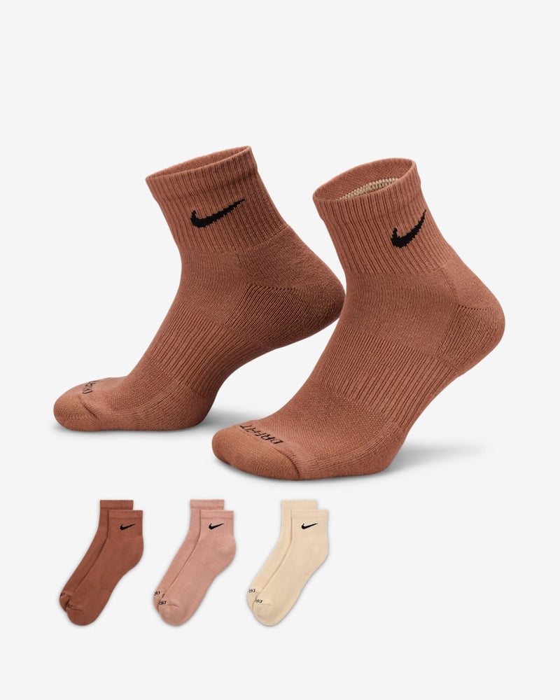 Nike Everyday Plus Cushioned Quarter Socks in brown with ribbed cuffs and black logo, displayed with additional color options in pink and beige.