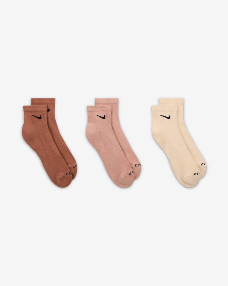 Nike Everyday Plus Cushioned Quarter Socks in brown, pink, and beige with ribbed cuffs and black logo detailing, front view.