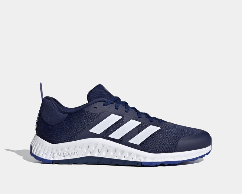 Adidas Everyset Trainer shoes in navy blue with white three-stripe design, mesh upper, and dual-density sole, side view.