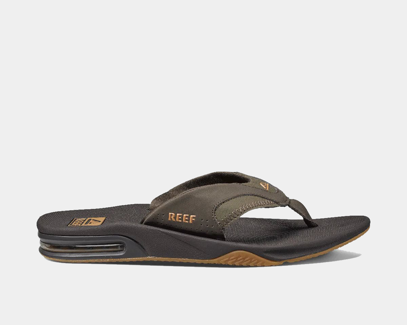 Reef Fanning Flip Flops in brown and black with synthetic strap, textured footbed, and air-cushioned heel, side view.