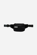 Nomadix Fanny Pack in black featuring a zippered main compartment, adjustable strap, and buckle closure, front view.