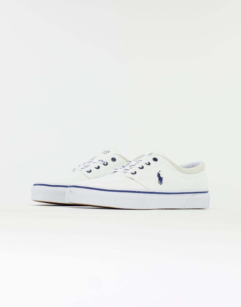 Polo Ralph Lauren Faxon X Canvas sneakers in white canvas with blue logo detailing and rubber sole, side angle view.