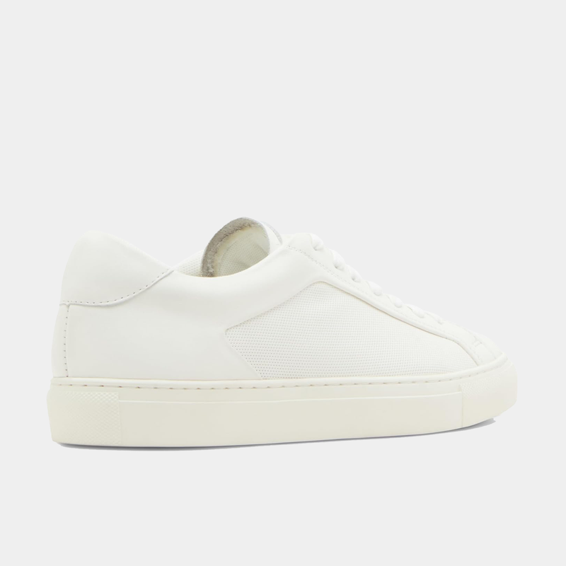 Steve Madden Finneas sneakers in all-white with smooth leather upper and textured side panels, side view.
