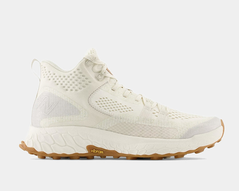 New Balance Foam X Hierro Mid GTX hiking shoes in off-white with Gore-Tex upper, Vibram outsole, and textured midsole, side view.