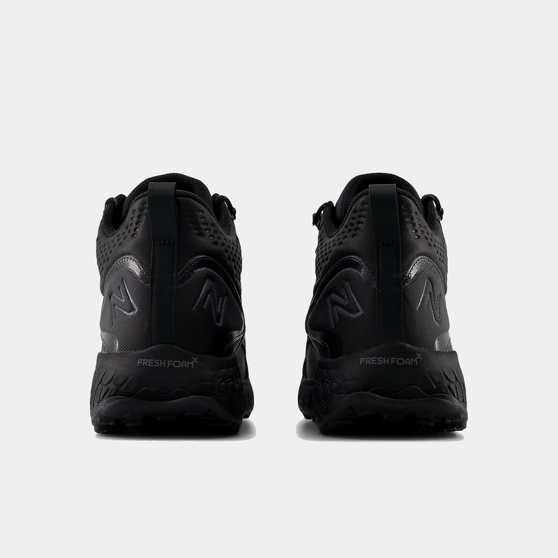 New Balance Foam X Hierro Mid GTX trail sneakers in black with Fresh Foam midsole and rugged heel design, back view.