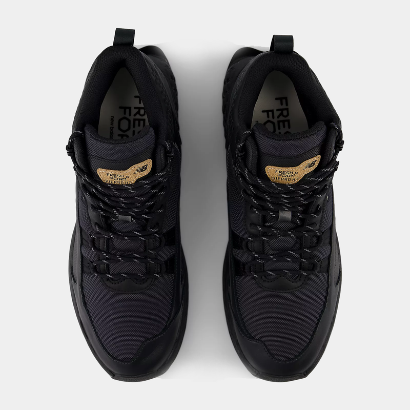 New Balance Foam X Hierro Mid GTX hiking shoes in black with gold tongue branding and Gore-Tex upper, top view.