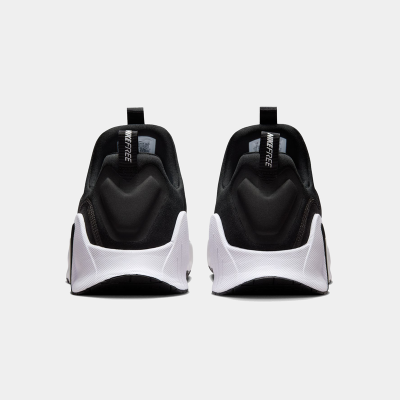 Nike Free Metcon 6 TB training shoes in black with white midsoles and pull tabs, back view showcasing heel design and branding.