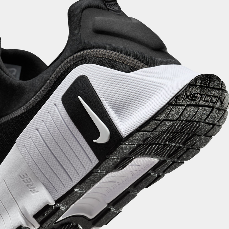 Nike Free Metcon 6 TB training shoes in black and white featuring reinforced heel and durable outsole, side and sole view.