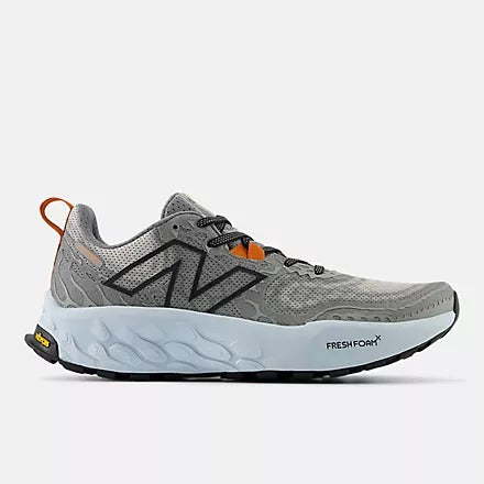 New Balance Fresh Foam Hierro v8 trail running shoes in gray with mesh upper, Vibram outsole, and orange heel tab, side view.