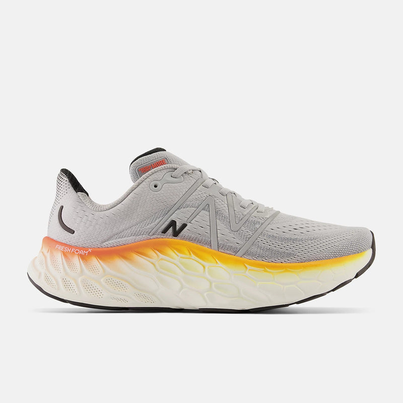 New Balance Fresh Foam More v4 running shoes in light gray with a mesh upper, gradient orange and yellow midsole, side view.