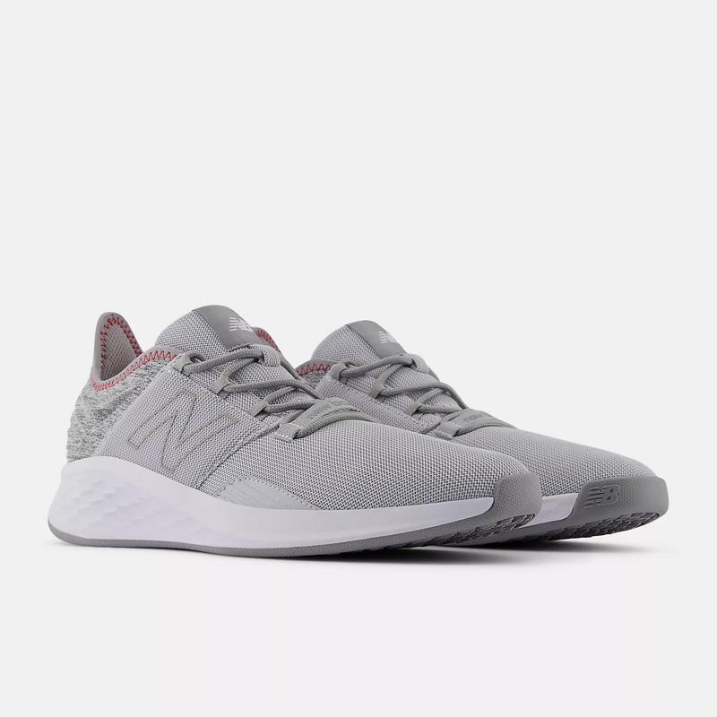 New Balance Golf Fresh Foam ROAV Golf shoes in light gray with breathable mesh upper, cushioned midsole, and contrast stitching, front angle view.
