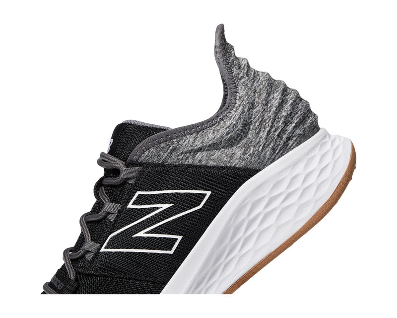 New Balance Golf Fresh Foam ROAV Golf shoes, black and gray mesh upper with white sole featuring textured cushioning, side view.