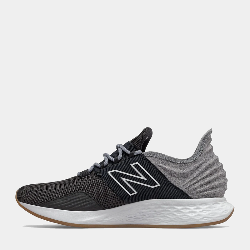 New Balance Fresh Foam Roav Tee Shirt running shoes in black and gray with a mesh upper, Fresh Foam midsole, and gum outsole, side view.