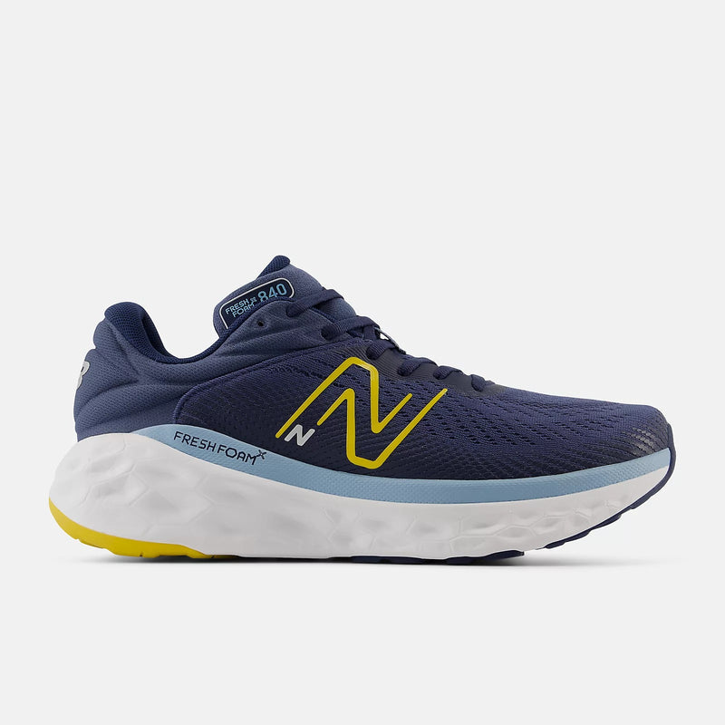 New Balance Fresh Foam X 840F running shoes in navy with yellow and light blue accents, side view highlighting Fresh Foam cushioning.