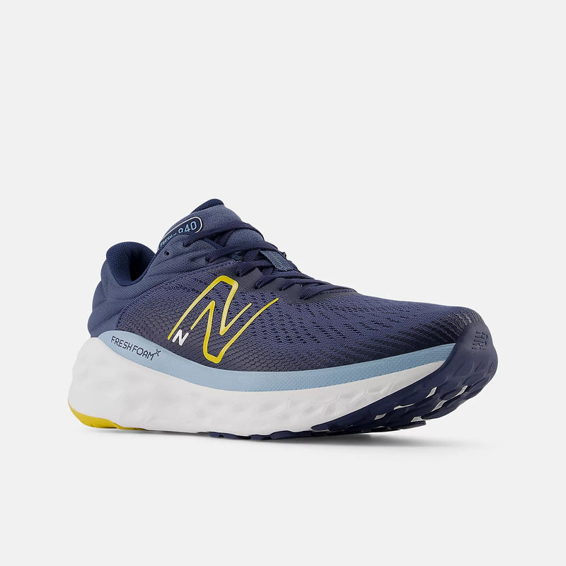 New Balance Fresh Foam X 840F running shoes in navy blue with yellow accents, mesh upper, and cushioned white midsole, front angle view.