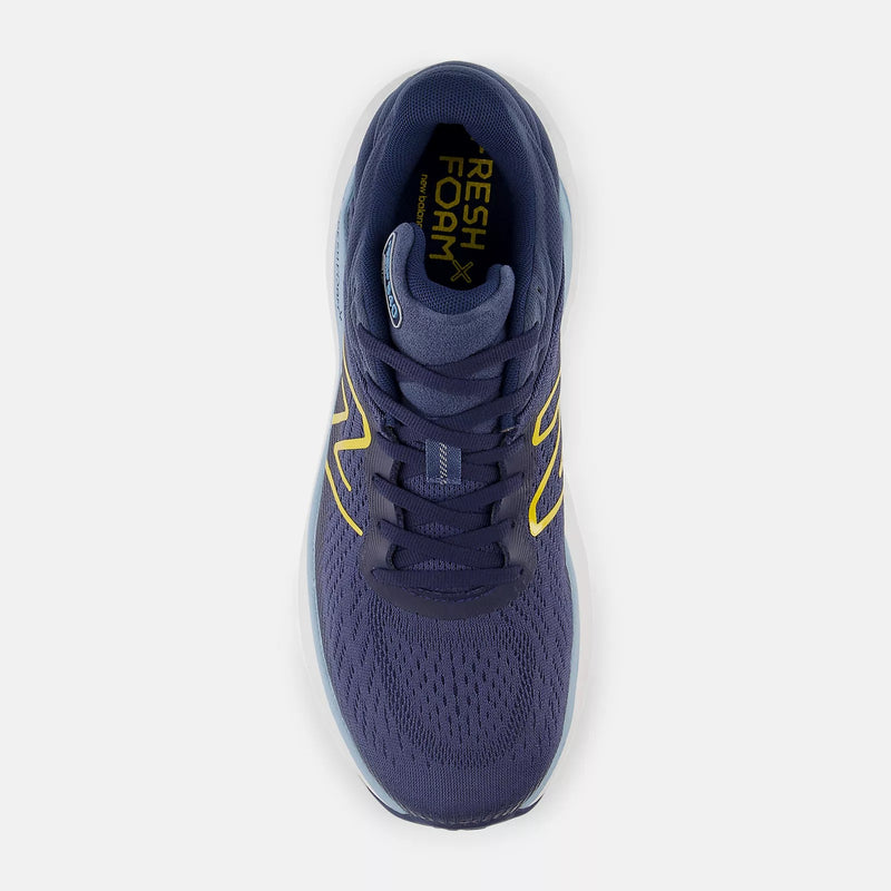 New Balance Fresh Foam X 840F running shoes in navy blue with yellow accents, breathable mesh upper, top view.