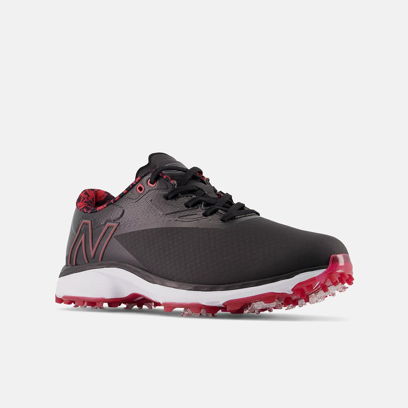 New Balance Golf Fresh Foam X Defender golf shoes in black and red with Fresh Foam midsole and spiked outsole, front side view.