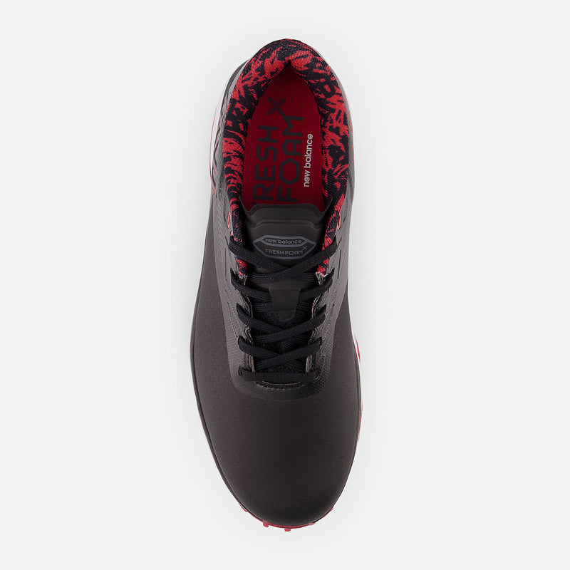 New Balance Golf Fresh Foam X Defender golf shoe in black with red interior accents and lace-up design, top view.