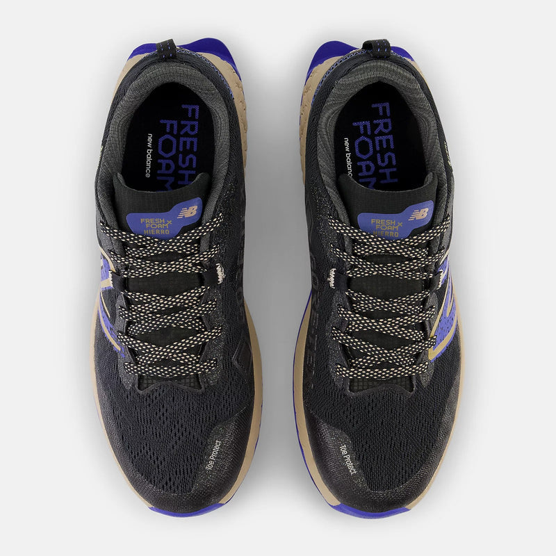 New Balance Fresh Foam X Hierro v7 Gore-Tex trail running shoes, black mesh upper with tan and purple accents, top view showing lace system and Gore-Tex branding.