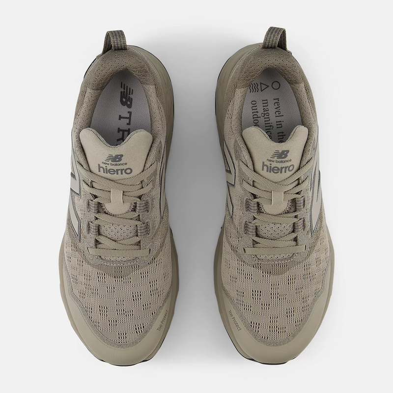 New Balance Fresh Foam X Hierro v9 trail running shoes in beige with textured mesh upper, lace-up closure, and pull tab, top view.