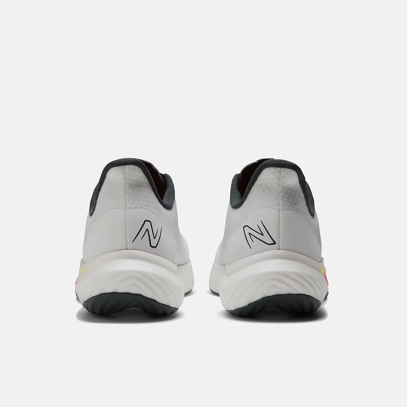 New Balance FuelCell Rebel v3 running shoes in white with black accents and logo detailing, back view showing heel design.