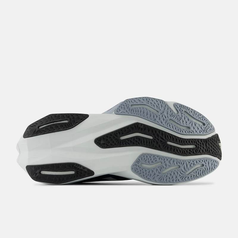 New Balance FuelCell Rebel v4 running shoes outsole in black and gray with textured grip pattern and durable rubber design.