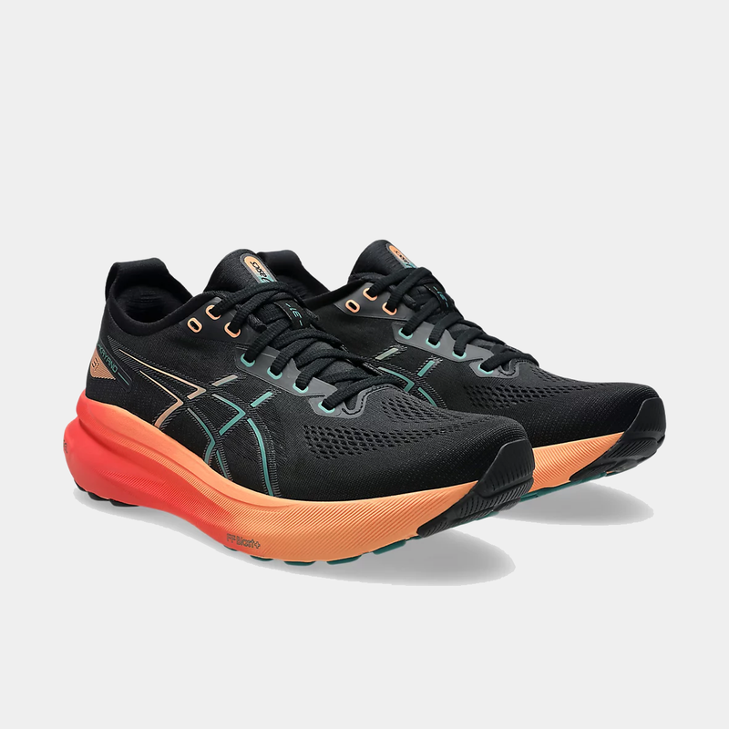 Asics Gel-Kayano 31 running shoes in black with orange midsoles, teal accents, and mesh uppers, front side angle view.