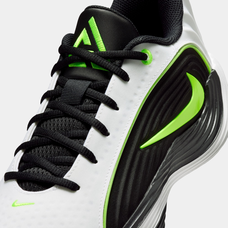 Nike Giannis Immortality 5 basketball shoes in white, black, and neon green, featuring mesh upper, bold Nike Swoosh, and textured midsole, close-up view.