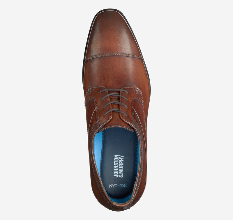 Johnston & Murphy Gibbons Cap Toe dress shoe in rich brown leather with cap toe design and lace-up closure, top view.