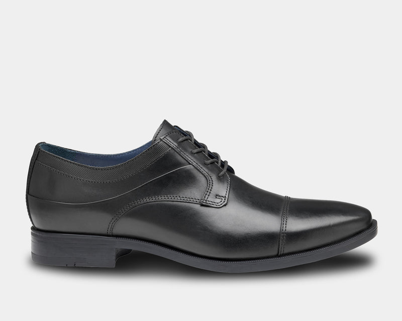Johnston & Murphy Gibbons Cap Toe dress shoes, black leather with sleek cap toe design and stitched detailing, side view.