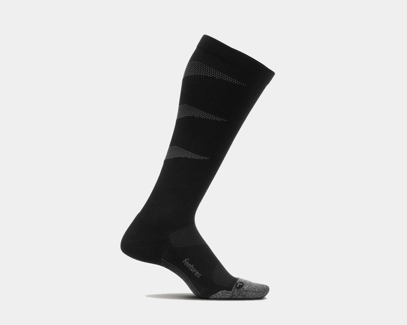 Feetures Graduated Compression Light Cushion Socks in black with gray accents, knee-high design, side view.