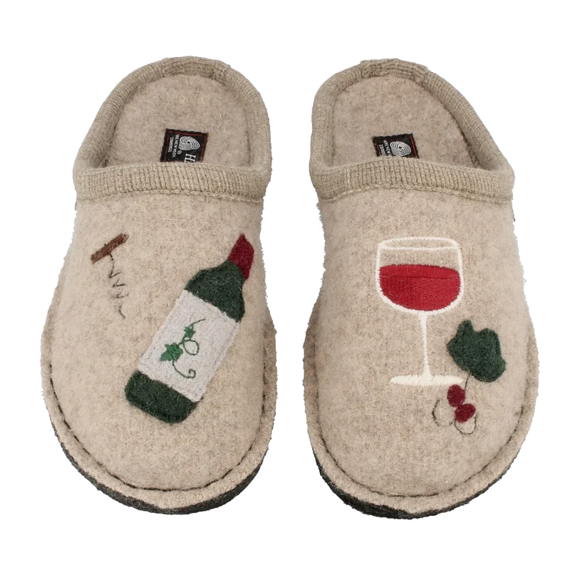 Beige Haflinger Winetime wool slippers with playful wine bottle and glass applique, warm boiled wool upper, and non-slip felt sole for cozy home comfort.