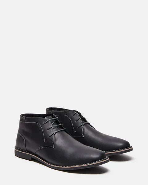 Steve Madden Harken boots in black leather with stitching accents and lace-up closure, angled front-side view.