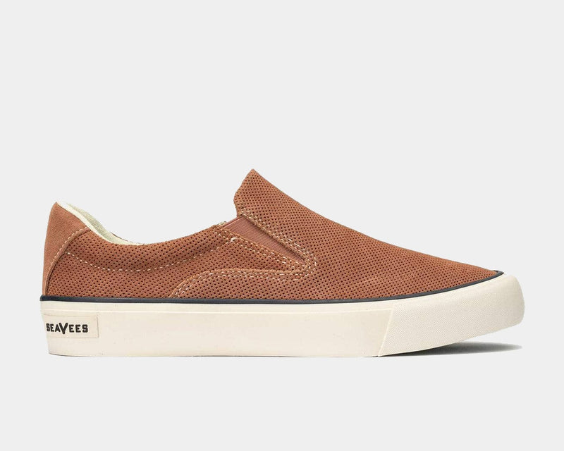 SeaVees Hawthorne Slip On shoes in light brown perforated suede with white rubber sole, side view.
