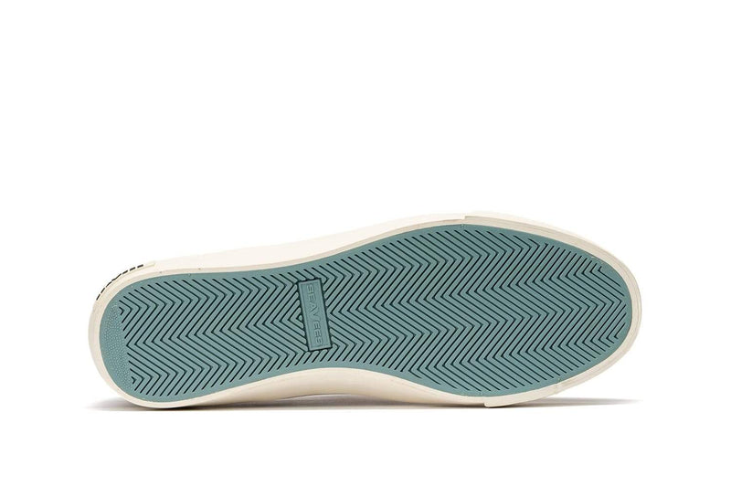 SeaVees Hawthorne Slip On sole view showing teal rubber outsole with herringbone tread pattern and embossed branding.