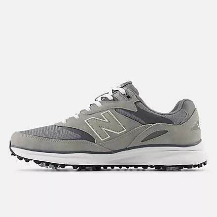 New Balance Golf Heritage Golf shoes in gray with mesh upper, synthetic overlays, and spiked sole, side view.