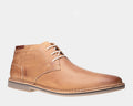 Steve Madden Heston chukka boots in tan leather with stitched detailing and lace-up closure, side view.