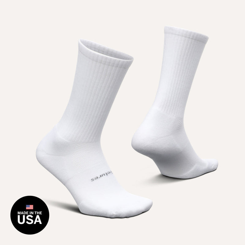 Feetures High Performance Max Cushion Crew socks in white with ribbed crew length design and reinforced cushioning, side angle view.
