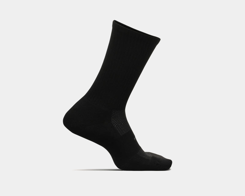 Feetures High Performance Max Cushion Crew socks in black with ribbed cuff and targeted compression zones, side profile view.