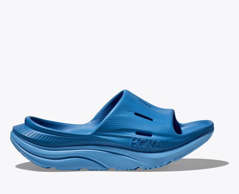 Side view of the HOKA ORA Slide 3 in blue. Features a cushioned dual-density sole, four airflow channels for breathability, and a sugarcane footbed for eco-friendly recovery and lifestyle comfort.