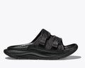 Side view of the HOKA ORA Luxe recovery slide in black. Features an adjustable Ariaprene foam and mesh strap, a cushioned sugarcane EVA midsole, and a lightweight design for post-run comfort.