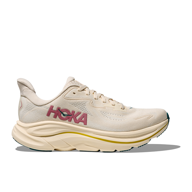Beige running shoe with pink 'Hoka' branding on a white background