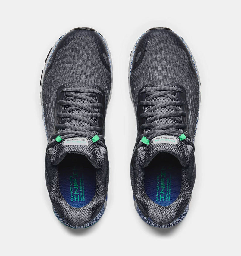 Under Armour HOVR™ Infinite 3 running shoes top view, dark gray mesh upper with green accents and cushioned insoles featuring branding.