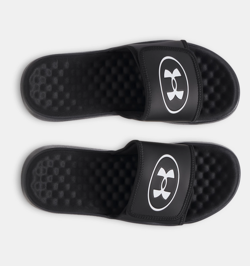 Under Armour Ignite Pro 8 slides in black with white logo, featuring textured foam footbed and adjustable strap, top view.